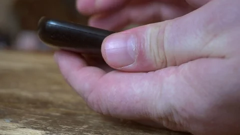 Outdated push button mobile phone in hand. Stock Footage 105422672