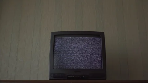 Outdated TV-set with flashing screen locates on table Stock Footage 120589519