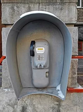 Outdated urban payphone Stock Photos