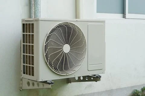 Outdoor air condition unit compressor install outside house's wall. Stock Photos