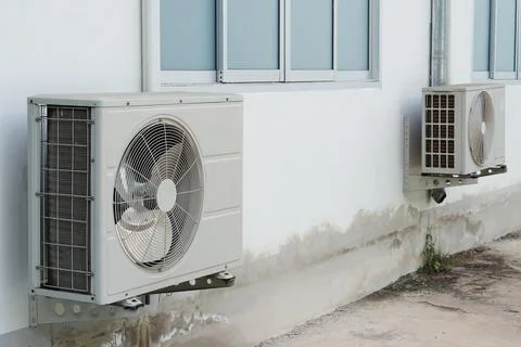 Outdoor air condition  unit compressor install outside house's wall. Stock Photos