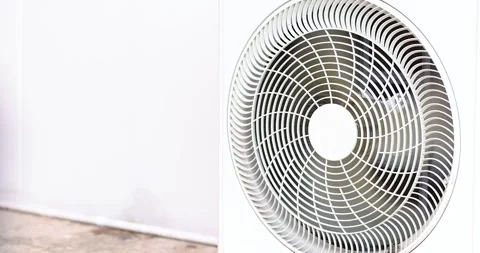 Outdoor air conditioner condenser unit with cooling fan operating. Ideal fo.. Stock Footage 338371865