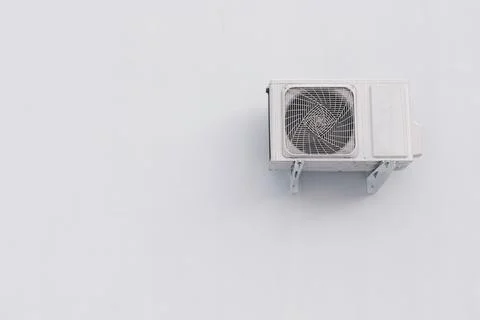 Outdoor air conditioner split system unit on white wall with copy space Stock Photos