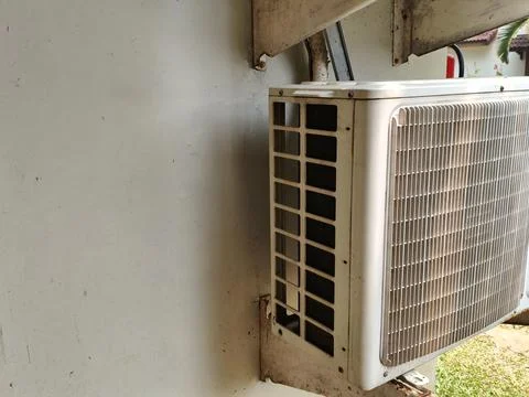 Outdoor air conditioning compressor unit mounted on wall Stock Photos