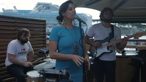 Outdoor Band Performance With Singer and Guitarist by Sydney Waterfront Stock Footage 345806779