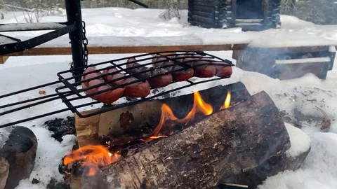 Outdoor barbecue over open flame in snowy landscape Stock Footage 122128267