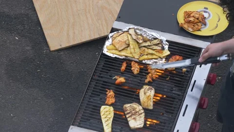 Outdoor barbeque grill flames cooks fish, vegetables and chicken Video stock 237828348