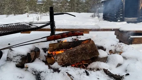 Outdoor barbeque over open flame in camping northern swedish lapland Stock Footage 122128204