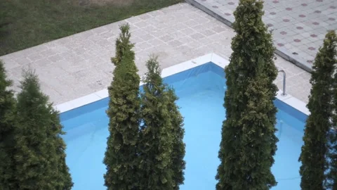 Outdoor blue pool in the backyard in cloudy weather Stock Footage 166548537