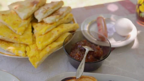 Outdoor breakfast setting featuring various delicious dishes Stock Footage 301402955