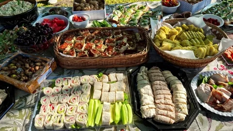 Outdoor Buffet Table Spread with Appetizers Fruit Meat and Snacks at Garden Stock Footage 341541928