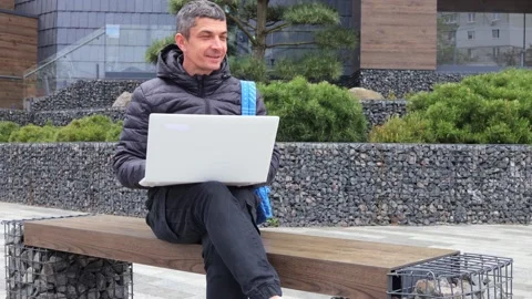 Outdoor business computer internet. Technology city laptop. Handsome Caucasian Stock Footage 292759687