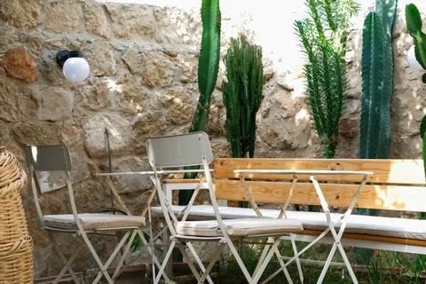 Outdoor cafe with cactus in old city. Table for romantic dinner. Moroccan style Stock Photos