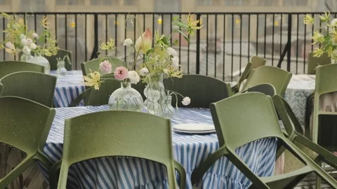 An outdoor cafe is closed due to bad weather, heavy rain. The tables are Stock Footage 318065645