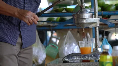 Outdoor cafe with freshly squeezed orange juice in Vietnam Stock Footage 319973369