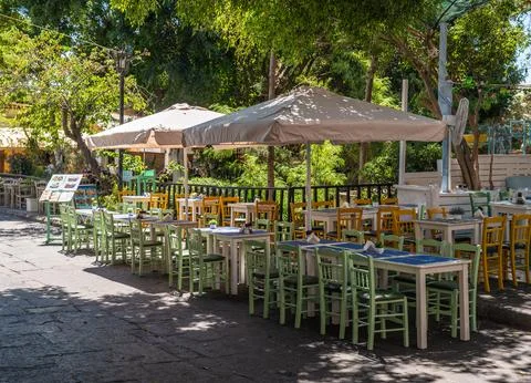 Outdoor Cafe Seating Under Trees in Old Town Rhodes Stock Photos