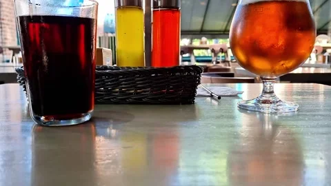 Outdoor Cafe Table with Refreshing Cold Drinks in Summer Sunlight Stock Footage 338426553