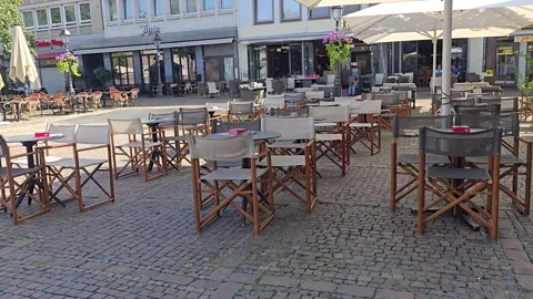 Outdoor cafe terrace with empty tables on a European square Stock Footage 341902985