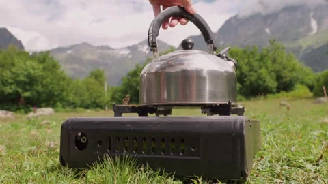 Outdoor camping kettle boiling water on portable stove 库存影片 301401855