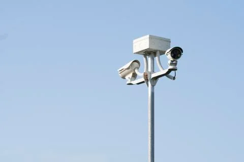 Outdoor CCTV Camera Operating for security in garden , on blue sky background Stock Photos