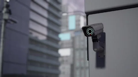 Outdoor CCTV Security Camera Mounted on Building Wall with Blurred City Video stock 331574191