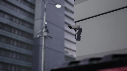 Outdoor CCTV Security Camera Mounted on Building Wall with Blurred City Video stock 331574251