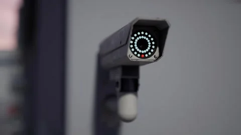 Outdoor CCTV Security Camera Mounted on Building Wall with Blurred City Video stock 331574283