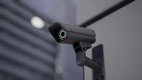 Outdoor CCTV Security Camera Mounted on Building Wall with Blurred City Video stock 331574330