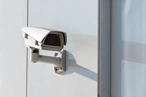 Outdoor cctv security camera mounted on white wall. Digital surveillance de.. Stock Photos