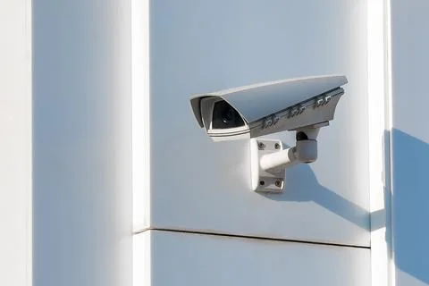 Outdoor cctv security camera mounted on white wall. Digital surveillance de.. Stock Photos