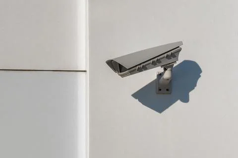 Outdoor cctv security camera mounted on white wall. Digital surveillance de.. Stock Photos