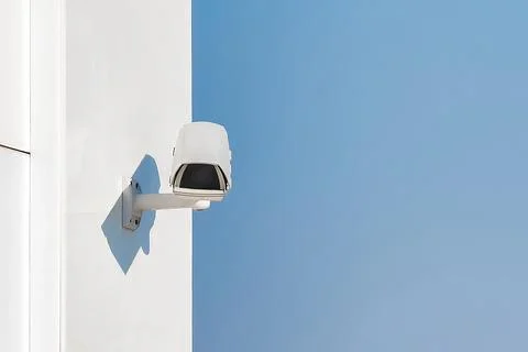 Outdoor cctv security camera mounted on white wall. Digital surveillance de.. Stock Photos