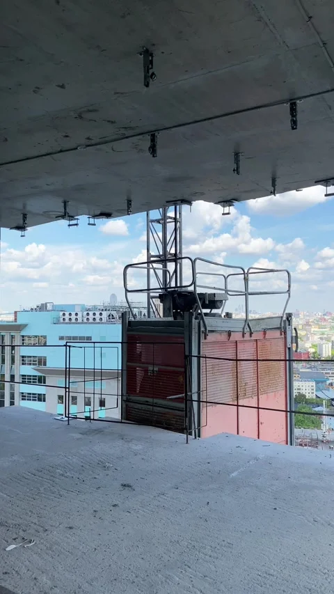 An outdoor construction elevator lifts workers to the heights Stock Footage 325206451