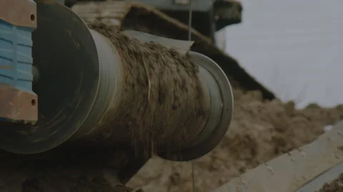 Outdoor conveyor with roller and gutter carries wet clay Stock Footage 255295765