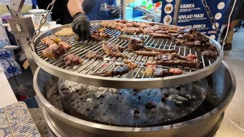 Outdoor cooking on large circular grill Stock Footage 268764218