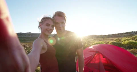 Outdoor couple taking sunset selfie while camping on hiking vacation Stock Footage