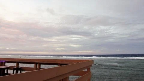 Outdoor deck overlooking a grey cloudy sky and sea Stock Photos