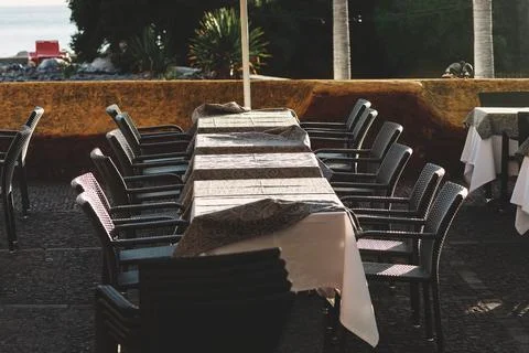 Outdoor dining area with a long table covered 写真素材