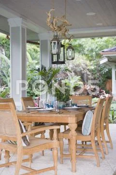 Outdoor Dining Area With Wooden Table And Chairs