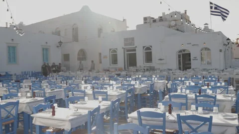 Outdoor Dining Setup with Blue Chairs in Paros, Greece Stock Footage 290134824