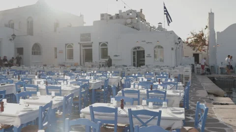 Outdoor Dining Setup with Blue Chairs in Paros, Greece Stock Footage 290135058