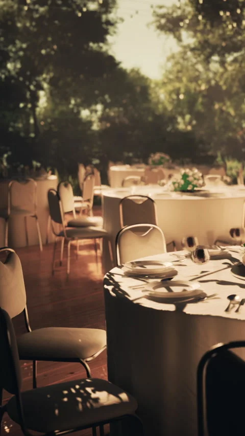 Outdoor dining setup at event venue with empty tables and chairs Stock Footage 337936480