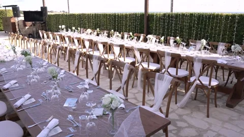 Outdoor dining setup for wedding celebration in sunny location with multiple Video stock 335912570