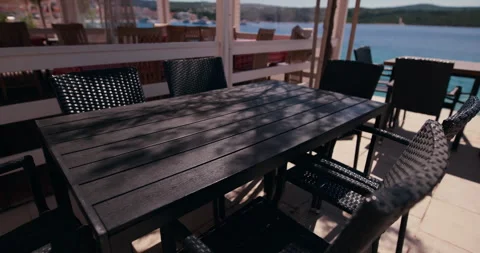 Outdoor Dining Table on Waterfront Terrace Stockbeeldmateriaal 336932598