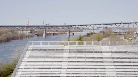 Outdoor empty bleachers with bridge &amp; river landscape Stock Footage 167777658