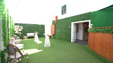 Outdoor event courtyard with artificial grass and hedge walls Stock Footage 345560809