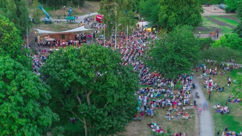 Outdoor Event Crowd Moving Through Park, Aerial Timelapse Stock Footage 343580103