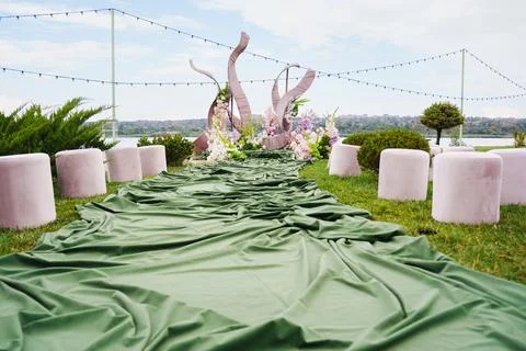 Outdoor event setup with green decor by the lake Stock Photos