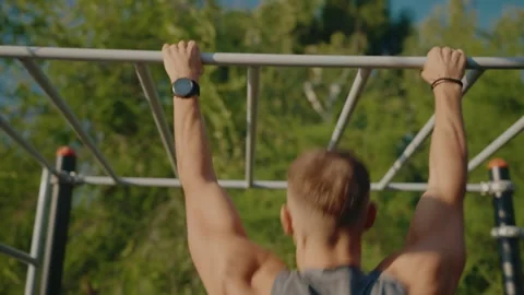 Outdoor Exercise with Hands Clutching Monkey Bars Under Blue Sky Stock Footage 309038566
