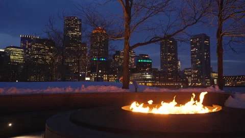 Outdoor fire pit burning bright on a winter night at Boston Fan Pier Park Stock Footage 303487906